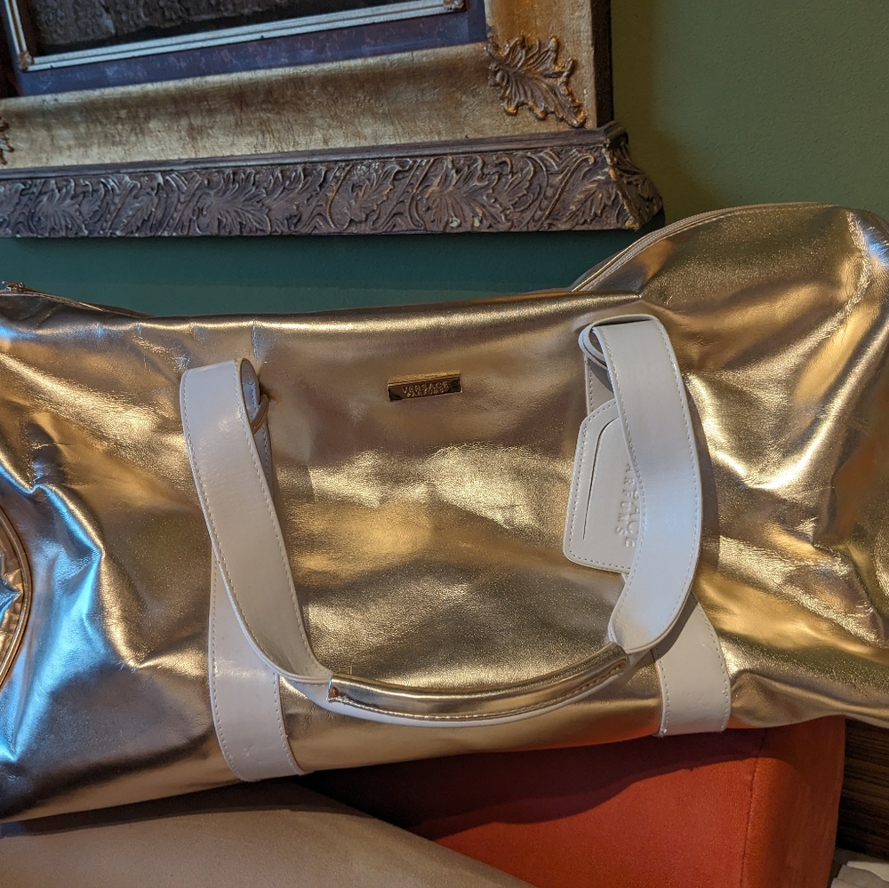 Versace Parfums gold duffel bag w/white handles & long detachable carrying strap